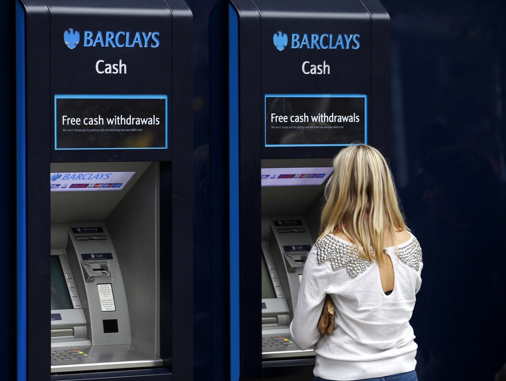 A customer uses a Barclays ATM in central London, July 23, 2010. Regulators have been looking at how banks would withstand another recession in an exercise similar to one in the United States last year which helped restore bank sector confidence. Some 91 lenders from 20 countries have faced the so-called stress tests. In Britain HSBC, Royal Bank of Scotland, Lloyds and Barclays, are being examined. REUTERS/Andrew Winning (BRITAIN - Tags: BUSINESS SPORT BASKETBALL POLITICS) - LM1E67N12I001