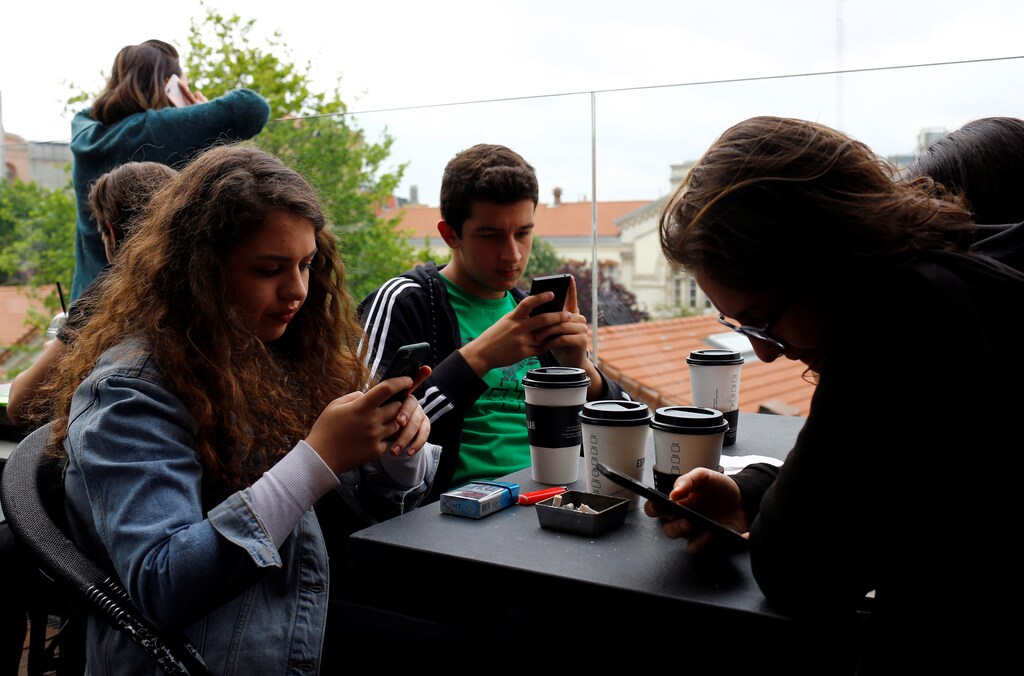 People use their mobile phones at a cafe in central Istanbul, Turkey May 18, 2017. Picture taken May 18, 2017. REUTERS/Murad Sezer - RTS19L4E