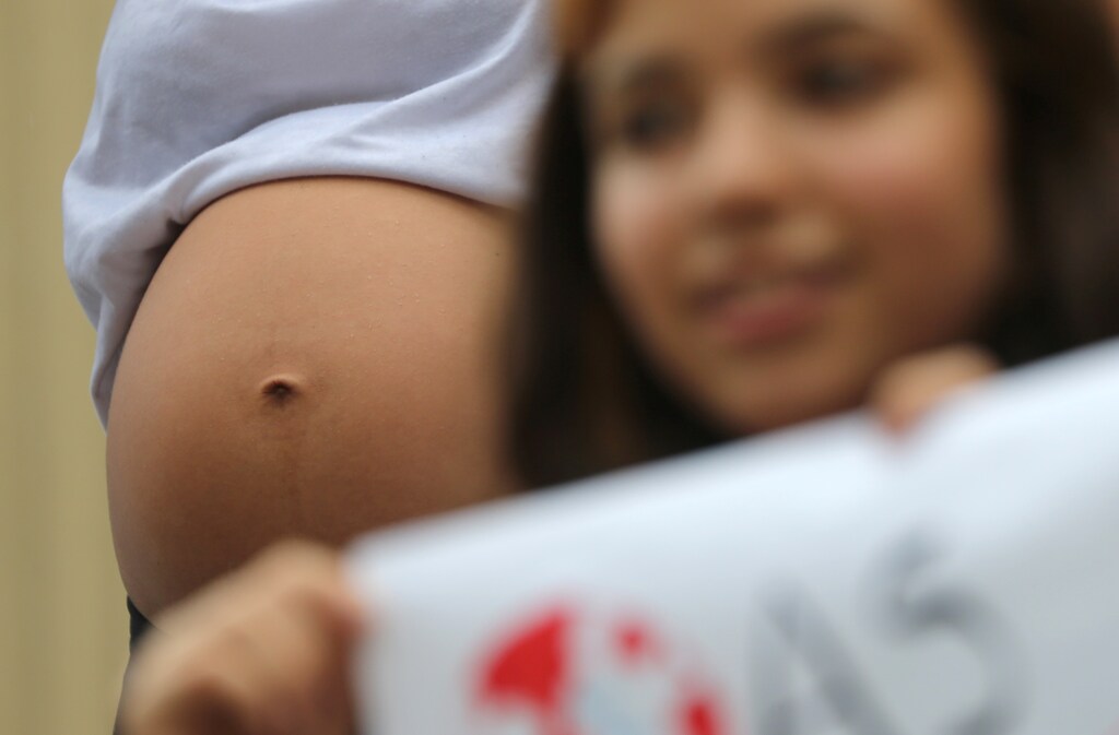 A pregnant student is seen during a demonstration to demand global action on climate change as part of the "Fridays for Future" movement in Rio de Janeiro, Brazil March 15, 2019. REUTERS/Sergio Moraes - RC1A4E591D90