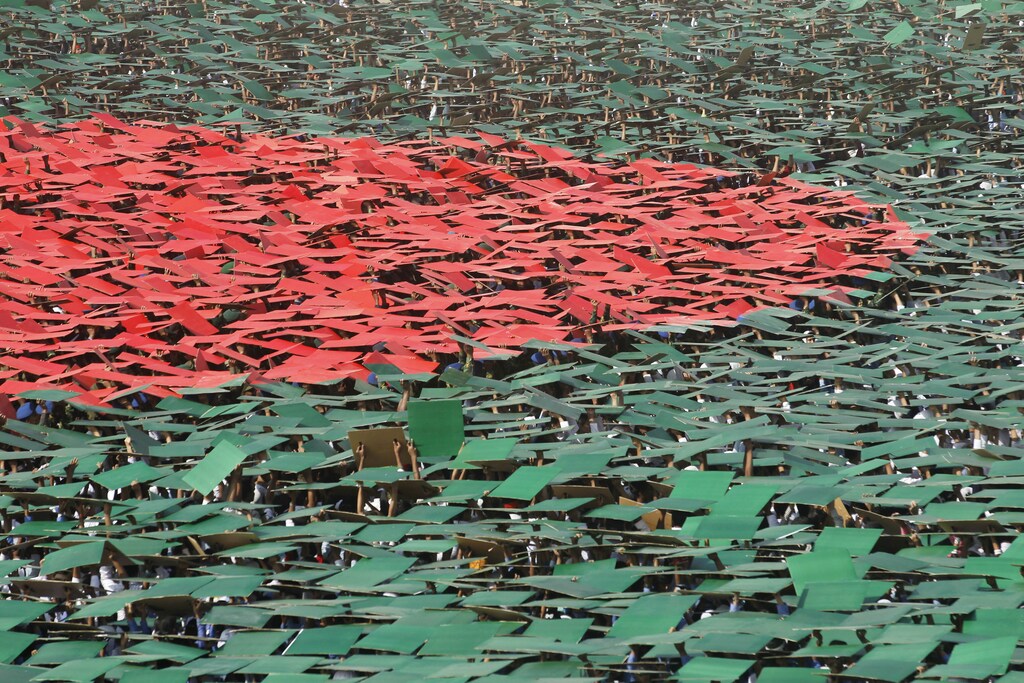 Volunteers prepare to form a large flag of Bangladesh as the nation celebrates National Victory Day at the National Parade ground in Dhaka December 16, 2013. According to the organizers, 27,117 volunteers formed a large human national flag for six minutes and sixteen seconds as they attempted to set a new Guinness world record. Bangladesh won independence from Pakistan on December 16, 1971, following a nine-month guerrilla war which cost millions of lives. REUTERS/Andrew Biraj (BANGLADESH - Tags: POLITICS ANNIVERSARY SOCIETY TPX IMAGES OF THE DAY) - GM1E9CG1C3K01