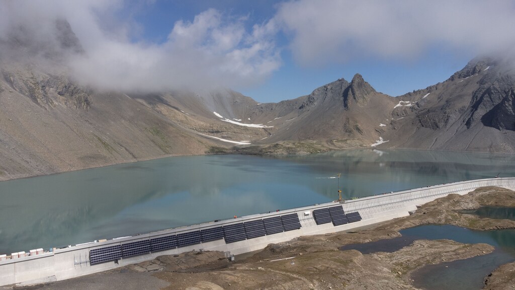 Solar panels are seen on the construction site of a large-scale photovoltaic system of Swiss energy provider Axpo at some 2500 metres above sea level on the dam of Lake Muttsee, Switzerland August 19, 2021. Picture taken with a drone, August 19, 2021
