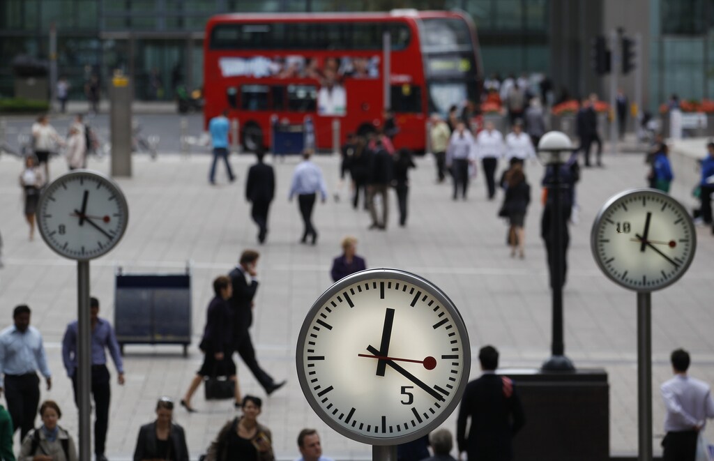 Pedestrians walk through the Canary Wharf business district in London September 12, 2011. Britain's banks face some of the world's toughest regulations under reforms outlined on Monday, which require them to insulate their retail lending activities and store up billions in extra capital at an annual cost of up to 7 billion pounds ($11 billion). REUTERS/Suzanne Plunkett (BRITAIN - Tags: BUSINESS POLITICS) - LM1E79C16AT01