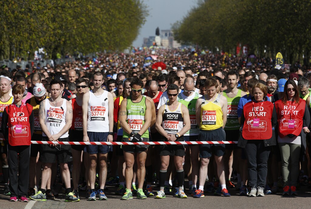 Runners observe a moment of silence before the start of the London Marathon in Greenwich, southeast London April 21, 2013. Undaunted by the Boston Marathon bombings, big crowds lined the route of the London Marathon on Sunday to cheer on some 36,000 runners who paid their respects to the Boston victims by wearing black ribbons and holding a 30-second silence before the start. ing off on the London Marathon on Sunday, under the watchful eyes of hundreds of extra police. REUTERS/Luke MacGregor (BRITAIN - Tags: SPORT ATHLETICS) - LM1E94L0RTC01