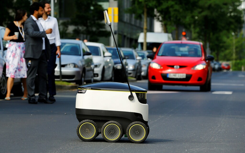 A Starship Technologies commercial delivery robot crosses a street during a live demonstration in front of the headquarters of Metro AG in Duesseldorf, Germany, June 7, 2016. REUTERS/Wolfgang Rattay/File Photo - S1BEUECOILAB
