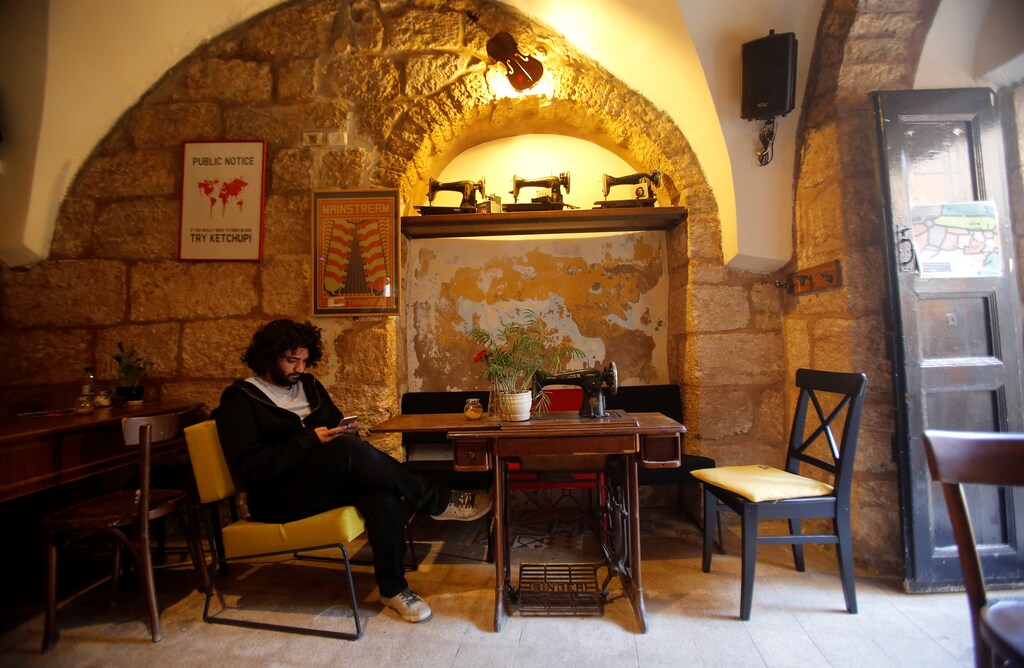 Palestinian musician Firas Harb uses Spotify app on his mobile phone in Beit Sahour, in the occupied West Bank November 20, 2018. Picture taken November 20, 2018. REUTERS/Mussa Qawasma - RC14479DD070