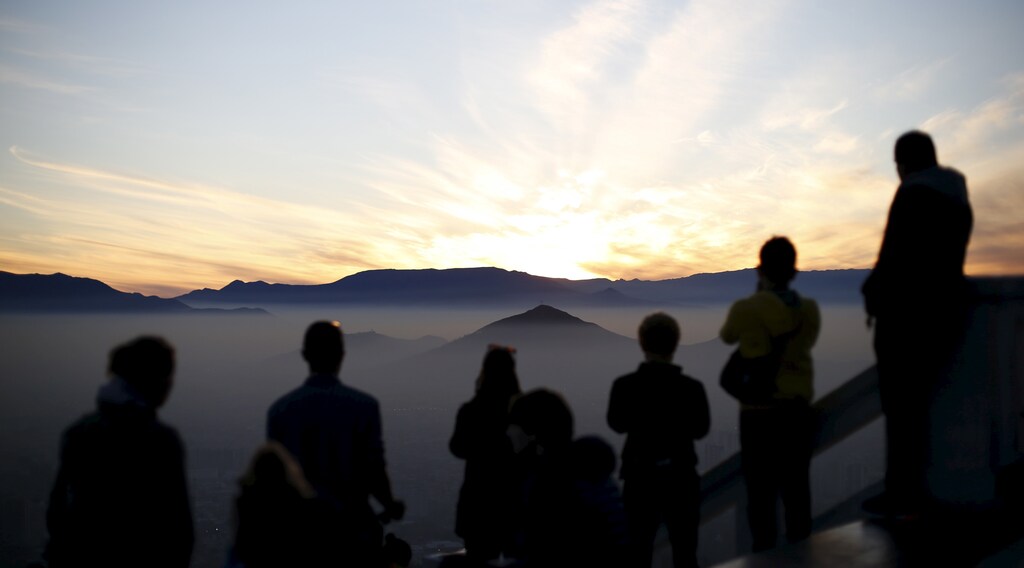 People gather atop of the San Cristobal Hill as smog shrouds Chile's capital Santiago June 22, 2015.