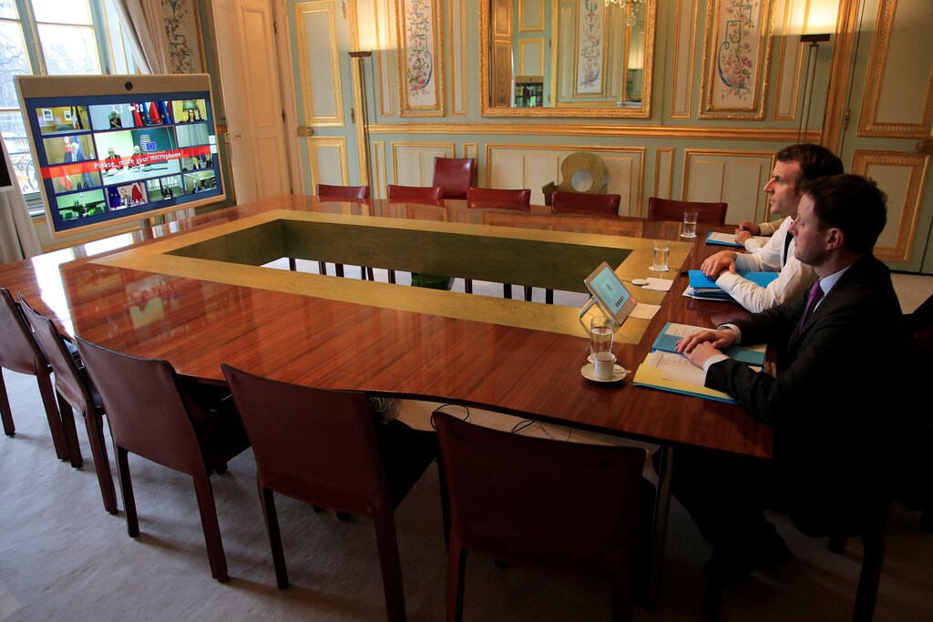 French President Emmanuel Macron and EU adviser Clement Beaune attend a videoconference at the Elysee Palace, in Paris, France March 10, 2020