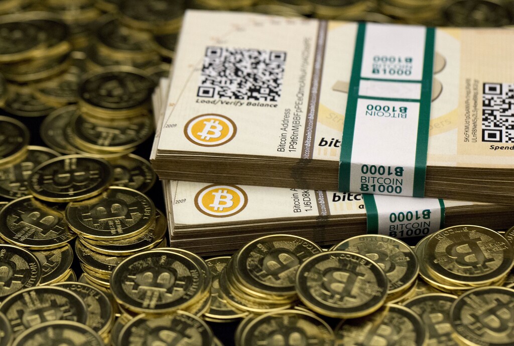 Some of Bitcoin enthusiast Mike Caldwell's coins and paper vouchers, often called "paper wallets", are pictured at his office in this photo illustration in Sandy, Utah, January 31, 2014.