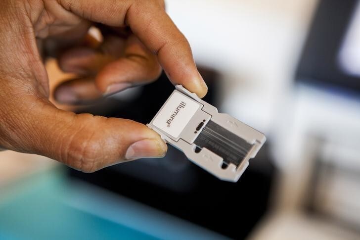 Suresh Chintalapati, an inside sales consultant with Illumina, displays a flow cell, the slide on which DNA is sequenced in the Miseq, a their bench top DNA sequencing machine, during a symposium on "The Future of Genomic Medicine" at Scripps Seaside Forum in La Jolla, California March 6, 2014. REUTERS/Sam Hodgson (UNITED STATES - Tags: HEALTH SCIENCE TECHNOLOGY)