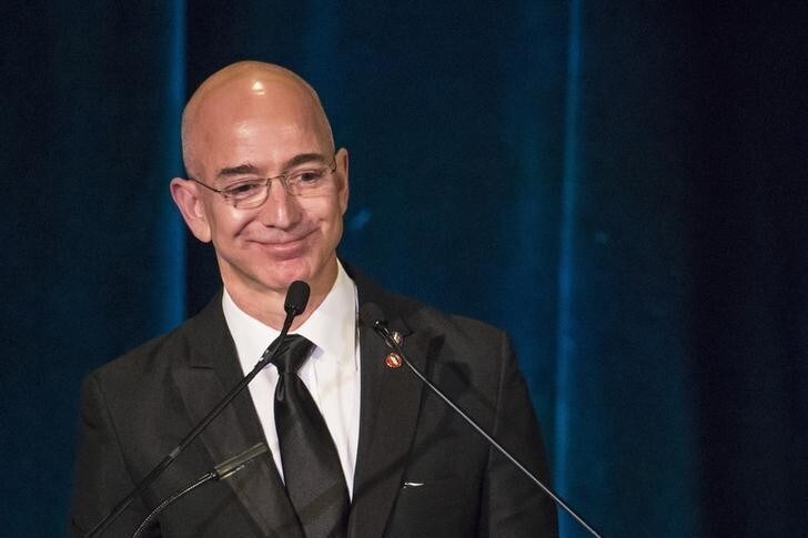 Amazon CEO and Chairman Jeff Bezos receives the Citation of Merit on behalf of the Apollo F-1 Search and Recovery Team at the 110th Explorers Club Annual Dinner at the Waldorf Astoria in New York March 15, 2014. The club, which promotes the scientific exploration of land, sea, air and space featured catering by chef and exotic creator Gene Rurka. Chef Rurka prepared a variety of dishes featuring an array of insects, wildlife, animal body parts and invasive species. REUTERS/Andrew Kelly (UNITED STATES - Tags: SOCIETY BUSINESS SCIENCE TECHNOLOGY FOOD)