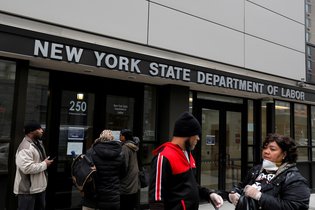 People gather at the entrance for the New York State Department of Labor offices, which closed to the public due to the coronavirus disease (COVID-19) outbreak in the Brooklyn borough of New York City, U.S., March 20, 2020.