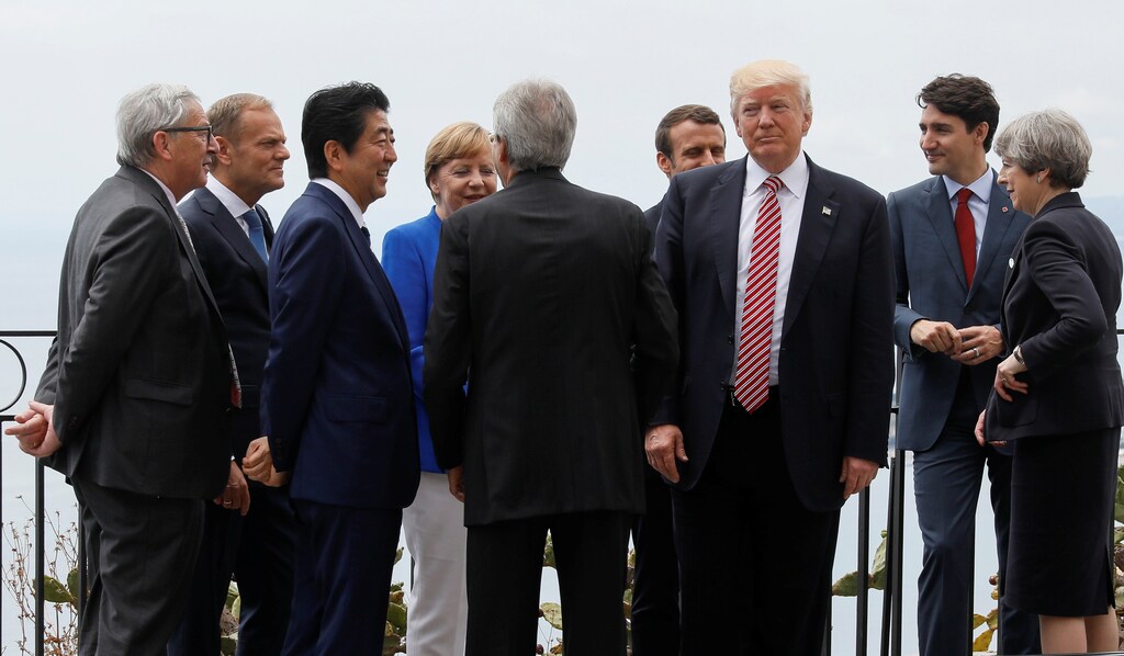 U.S. President Donald Trump gathers with (L-R) European Commission President Jean-Claude Juncker, European Council President Donald Tusk, Japanese Prime Minister Shinzo Abe, German Chancellor Angela Merkel, Italian Prime Minister Paolo Gentiloni, French President Emmanuel Macron, Canadian Prime Minister Justin Trudeau and Britains Prime Minister Theresa May as they attend the G7 Summit in Taormina, Sicily, Italy, May 26, 2017. REUTERS/Jonathan Ernst TPX IMAGES OF THE DAY - RTX37QEG