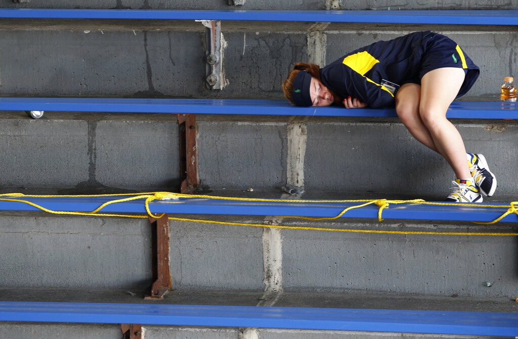 A girl naps in the stands at the U.S. Open tennis tournament in New York August 27, 2012. REUTERS/Jessica Rinaldi (UNITED STATES - Tags: SPORT TENNIS) - TB3E88R1MH73E