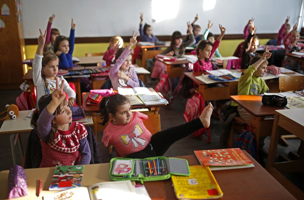 Ramela Meseljevic, a 7 year-old girl born without both of her hands and one of her legs shorter than the other, attends classes in the her school in Begov Han, Bosnia and Herzegovina December 2, 2015. International Day of Disabled Persons is observed on December 3 with the theme "Inclusion matters: access and empowerment of people of all abilities". Picture taken on December 2, 2015. REUTERS/Dado Ruvic - D1AERZEBNQAB