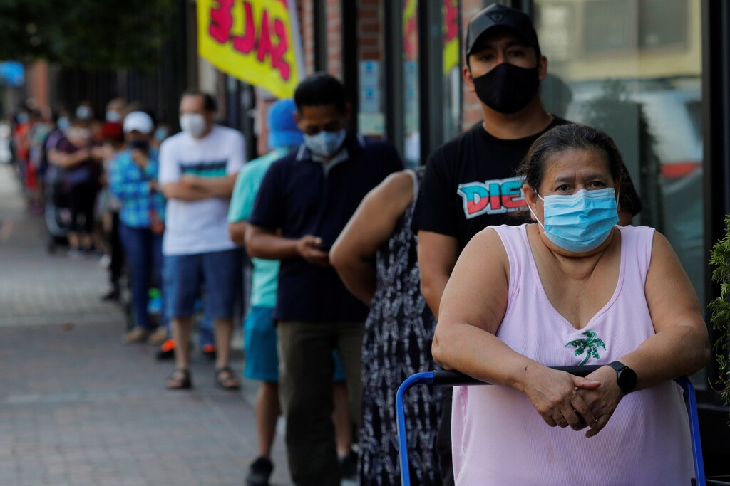 People wait in line for free groceries distributed by the Chelsea Collaborative in a city hard hit by the coronavirus disease (COVID-19) outbreak, in Chelsea, Massachusetts, U.S., July 22, 2020. REUTERS/Brian Snyder - RC2OYH9PQJK8
