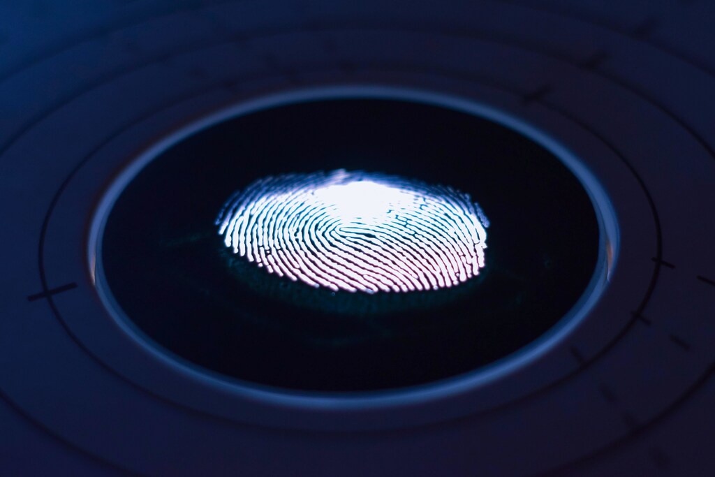 White fingerprint on black background; digital identity ecosystem; touchscreen