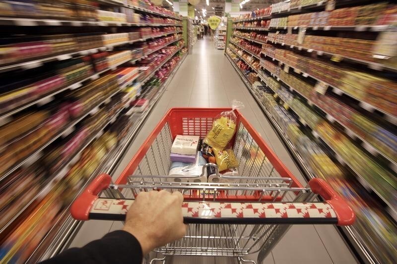 A shopping cart is pushed down the aisle in this photo illustration taken at Mercator shopping mall in Ljubljana, January 28, 2014.