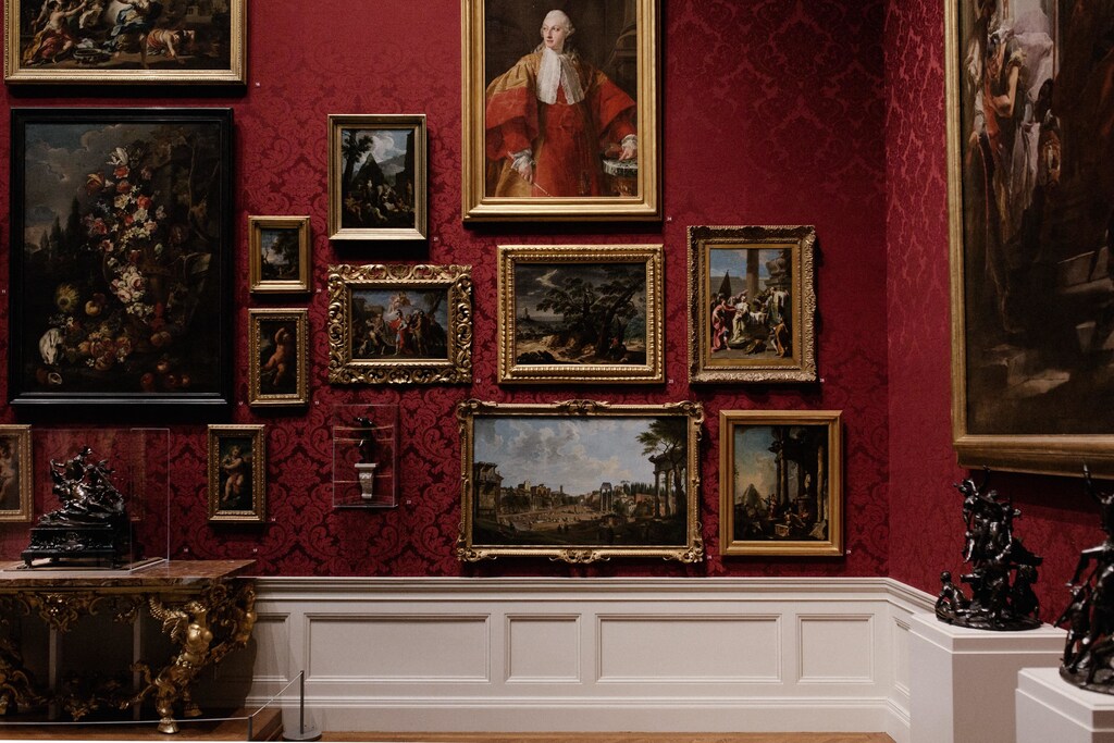 Assorted paintings on the wall in an art gallery.