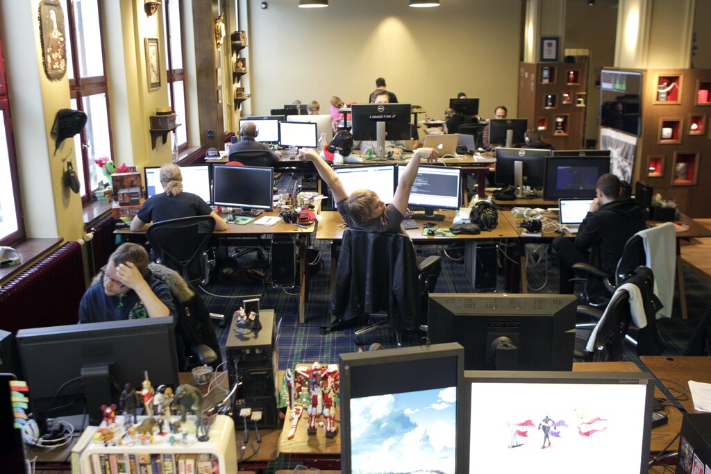 Coders work in the Mojang company office in Stockholm January 21, 2013. A pool table, a pinball machine, board games and Lego dot the offices of Mojang, the small Swedish company behind the wildly popular Minecraft video game, and one of its founders is wearing a tuxedo and purple tie on a recent "formal Friday". The atmosphere reflects the independent spirit that has contributed to the raw identity of the game that has just sold 20 million copies. The founders want to keep it that way. Mojang, the Swedish word for gadget, has so far resisted selling to a bigger player or listing on the stock market even though that could mean monster payoffs for the 25-person staff and funding to expand dramatically its games. Picture taken January 21, 2013. REUTERS/Ints Kalnins (SWEDEN - Tags: BUSINESS) - GM1E9241CY501