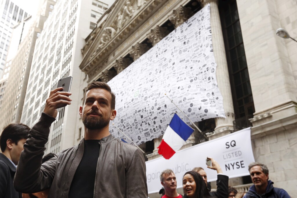 Jack Dorsey, CEO of Square and CEO of Twitter, uses his phone to live cast during an event outside of the New York Stock Exchange to celebrate the IPO of Square Inc., in New York November 19, 2015. Square Inc priced shares at $9 for its initial public offering, about 25 percent less than it had hoped, as it struggled to win over investors skeptical about its business and valuation before trading begins on Thursday. REUTERS/Lucas Jackson - RTS7Z1G