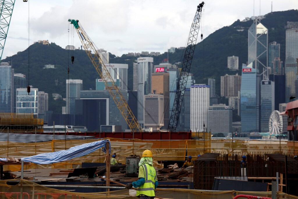 A worker stands on a construction site as part of the West Kowloon Terminus project for the Guangzhou-Shenzhen-Hong Kong Express Rail Link in Hong Kong, China July 21, 2017. Picture taken July 21, 2017. REUTERS/Bobby Yip - RTX3CSAC