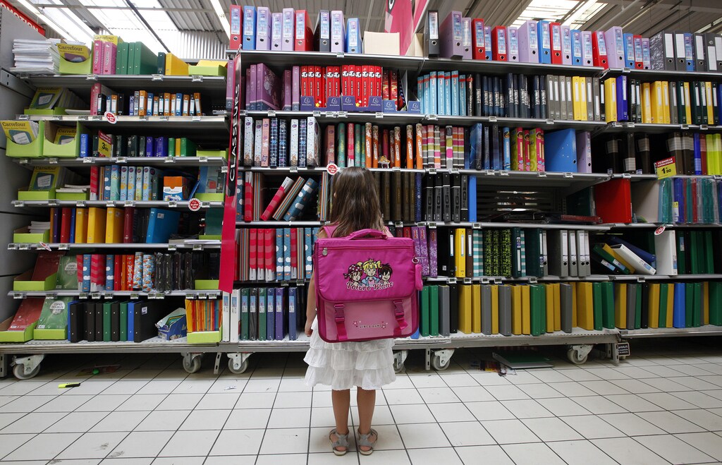 A young girl looks at school stationery in a supermarket in Nice August 23, 2012. The new school year will start on September 4 in France. REUTERS/Eric Gaillard (FRANCE - Tags: EDUCATION SOCIETY BUSINESS) - PM1E88N1BPD01