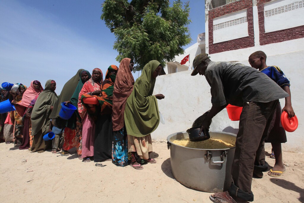 Displaced Somali women queue for food at a centre run by a Turkish aid agency in the Howlwadaag district of southern Mogadishu, January 22, 2012. From Turkey to Brazil, India to Saudi Arabia, a growing number of non-Western donors are bringing fresh funds, a different mindset and their own experience of managing natural disasters to the global humanitarian aid scene. Picture taken January 22, 2012: Global aid is undergoing major upheaval