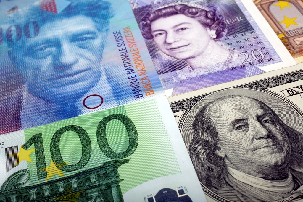A picture illustration of U.S. dollar, Swiss Franc, British pound and Euro bank notes.