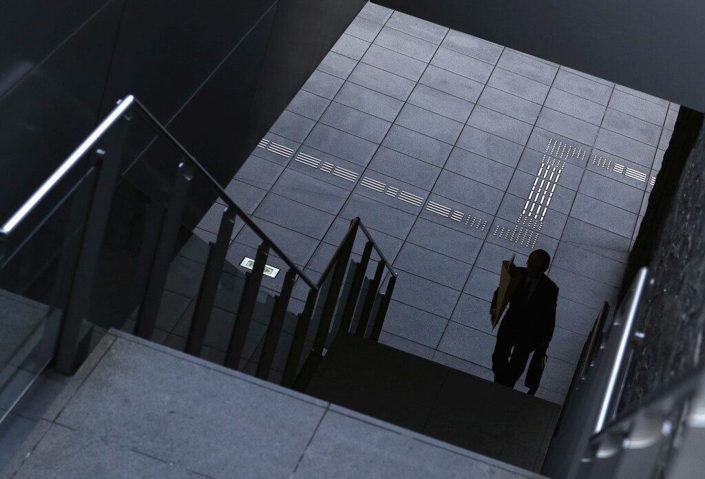 A man goes up the stairs at Tokyo's business district.