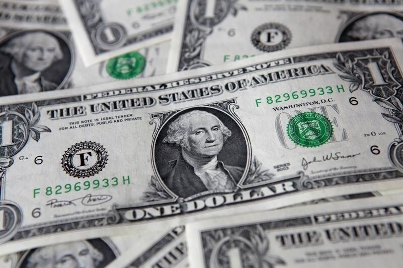 U.S. dollar banknotes lie on a table in this picture illustration taken in Warsaw August 8, 2011. Deep-rooted jitters about the U.S. debt rating cut sent world stocks tumbling towards 11-month lows on Monday, overshadowing relief that the European Central Bank was buying bonds of strugglers Italy and Spain. REUTERS/Kacper Pempel (POLAND - Tags: BUSINESS) - GM1E7881N2B01