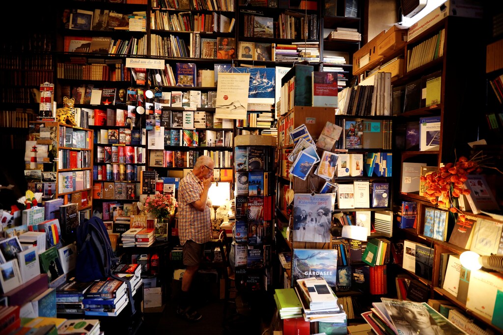 A customer stands in Vienna's smallest bookstore, 'Buchhandlung Posch'.