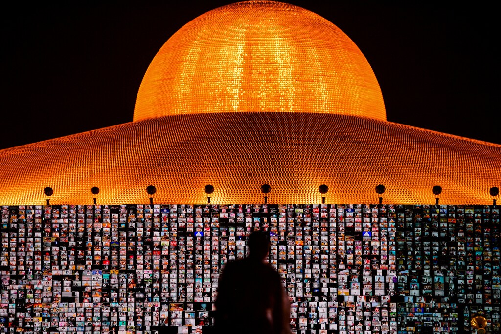 People pray as screens show devotees gathering via Zoom application during a ceremony to commemorate the Buddhist Lent Day at the Wat Phra Dhammakaya temple, amid the coronavirus disease (COVID-19) outbreaks, in Pathum Thani province, Thailand, July 24, 2021. REUTERS/Chalinee Thirasupa TPX IMAGES OF THE DAY - RC2ZQO9KWXY2