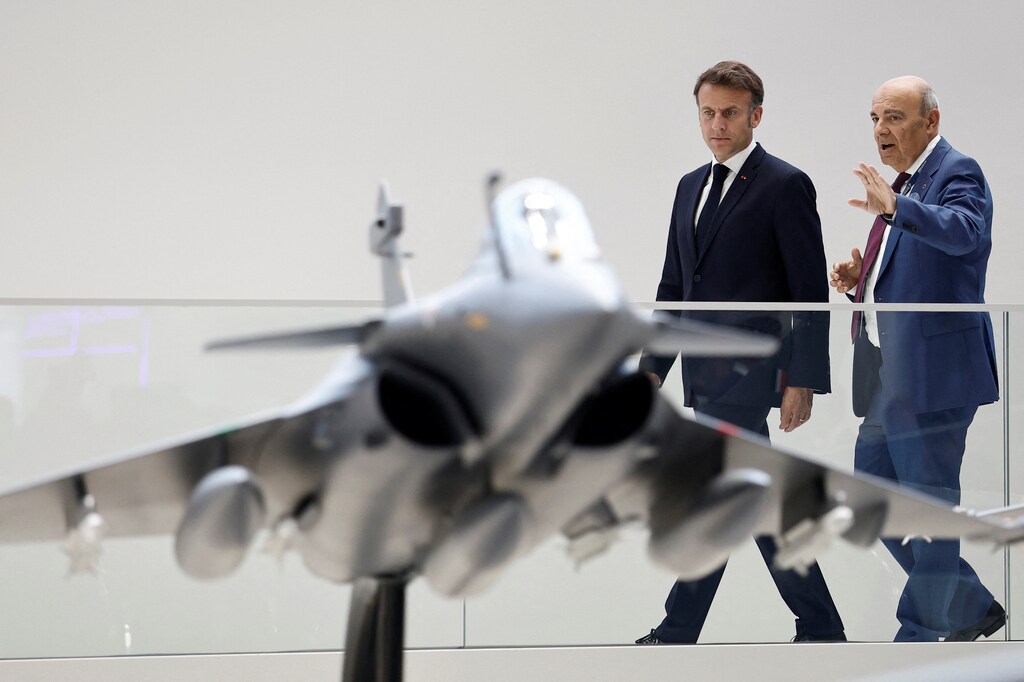 French President Emmanuel Macron listens to Eric Trappier, Chairman and Chief Executive Officer of Dassault Aviation, as they look at a display model of a Rafale fighter jet at the stand of aircraft manufacturer Dassault Aviation during a visit at the 55th International Paris Airshow at Le Bourget Airport near Paris, France, June 20, 2025: The Paris Air Show 2025 highlighted the industry's transition from ambition to implementation