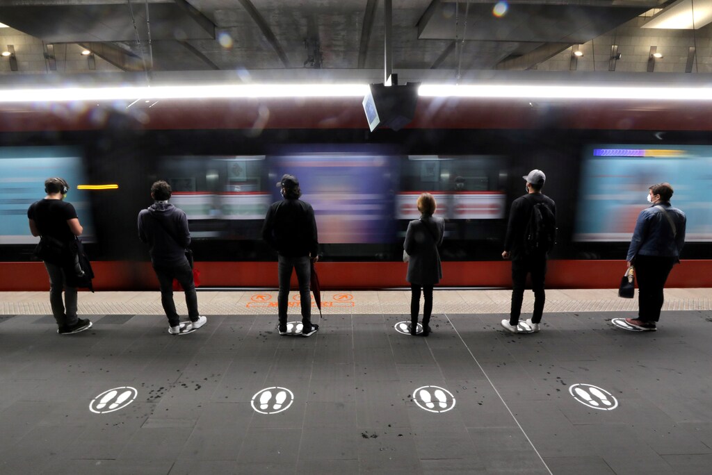 People stand on signs to respect social distancing on a platform for the tramway in Nice as France begun a gradual end to a nationwide lockdown due to the coronavirus disease (COVID-19), France, May 11, 2020. REUTERS/Eric Gaillard TPX IMAGES OF THE DAY - RC27MG9CYF7G