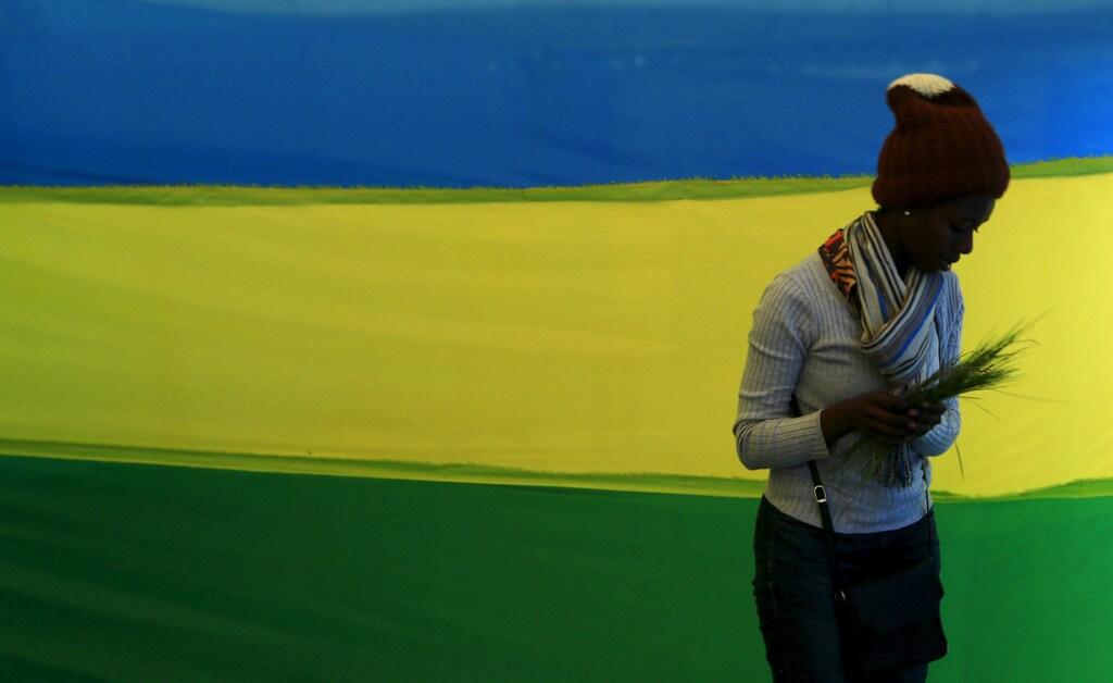 A woman walks past a Rwanda flag at a polling station on the eve of a referendum as Rwandans will vote to amend its Constitution to allow President Paul Kagame to seek a third term in capital Kigali, December 17, 2015, REUTERS/James Akena - GF10000269406