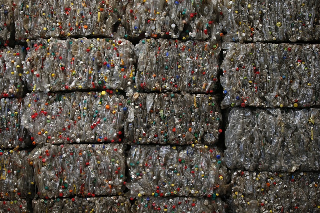 Piles of plastic PET bottles are seen at Asia's largest PET plastic recycling factory INCOM Resources Recovery in Beijing May 7, 2013. According to government figures, reported in local media, about 4.67 million tons of recyclable waste was collected in Beijing in 2010. In the same year, 6.35 million tons of trash ended up in landfill in the city. World Environment Day is celebrated annually on June 5. Picture taken May 7, 2013. REUTERS/Kim Kyung-Hoon (CHINA - Tags: ENVIRONMENT SOCIETY) - GM1E9650KFF01