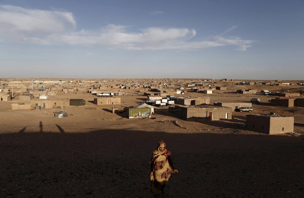 An indigenous Sahrawi woman walks at a refugee camp of Boudjdour in Tindouf, southern Algeria March 3, 2016. In refugee camps near the town of Tindouf in arid southern Algeria, conditions are hard for indigenous Sahrawi residents. Residents use car batteries for electricity at night and depend on humanitarian aid to get by. The five camps near Tindouf are home to an estimated 165,000 Sahrawi refugees from the disputed region of Western Sahara, according to the United Nations refugee agency UNHCR. REUTERS/Zohra Bensemra TPX IMAGES OF THE DAY SEARCH "THE WIDER IMAGE" FOR ALL STORIES Matching text ALGERIA-SAHARA/ - RTS9CDG