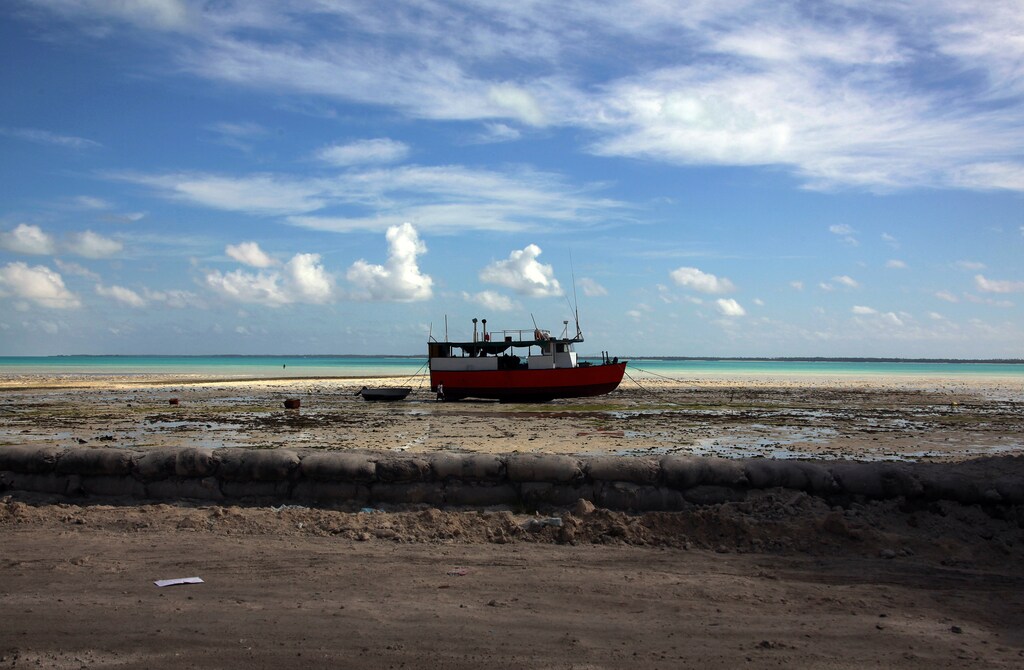 A boat sits on a reef-mud flat close to a lagoon at South Tarawa in the central Pacific island nation of Kiribati May 23, 2013. Kiribati consists of a chain of 33 atolls and islands that stand just metres above sea level, spread over a huge expanse of otherwise empty ocean. With surrounding sea levels rising, Kiribati President Anote Tong has predicted his country will likely become uninhabitable in 30-60 years because of inundation and contamination of its freshwater supplies. Picture taken May 23, 2013. REUTERS/David Gray (KIRIBATI - Tags: ENVIRONMENT POLITICS SOCIETY)ATTENTION EDITORS: PICTURE 04 OF 42 FOR PACKAGE 'KIRIBATI - GONE IN 60 YEARS'. SEARCH 'KIRIBATI' FOR ALL IMAGES - LM2E96A14CL01