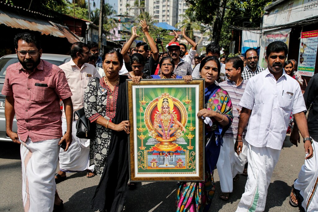 Protesters hold a portrait of Hindu deity Ayappa as they take part in a rally called by various Hindu organisations after two women entered the Sabarimala temple, in Kochi, India, January 2, 2019. REUTERS/Sivaram V - RC15D0A67BD0