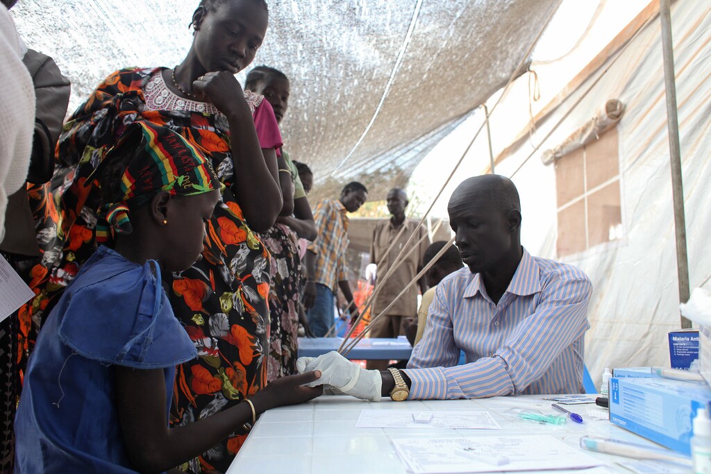 A displaced girl is tested for malaria at an MSF clinic in Tomping camp, where some 17,000 displaced people who fled their homes are being sheltered by the United Nations, in Juba January 10, 2014. Violence erupted in South Sudan's capital Juba in mid-December and spread to oil-producing regions and beyond, dividing the two-year-old land-locked country along ethnic lines. Some 60,000 civilians are being protected at U.N. Bases. REUTERS/Andreea Campeanu (SOUTH SUDAN - Tags: CIVIL UNREST SOCIETY HEALTH) - GM1EA1A1J0I01