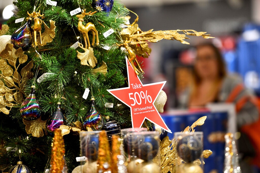 Christmas tree with a sale sign in an American shopping mall. Would you go into debt for Christmas?