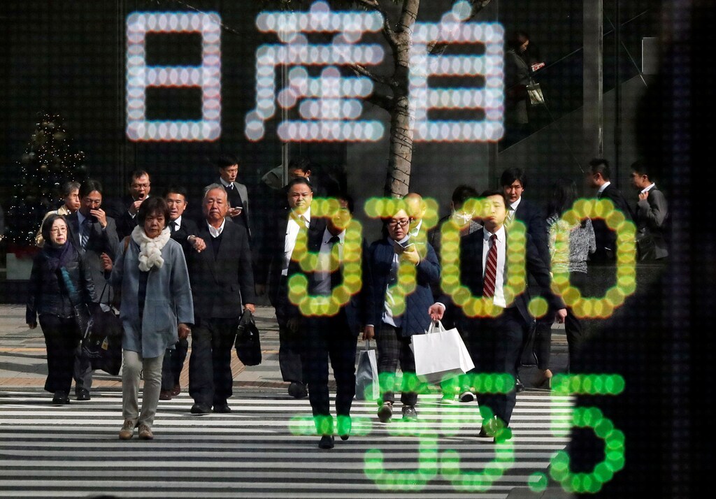 People are reflected in a stock quotation board showing share price of Nissan Motor Co outside a brokerage in Tokyo, Japan November 20, 2018. REUTERS/Toru Hanai - RC1F5F10C830