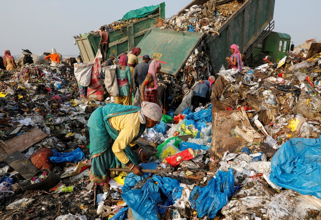 image of waste collectors at a landfill in India