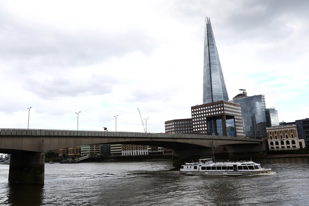 A tourist boat travels along the River Thames under London Bridge, after attackers rammed a hired van into pedestrians on London Bridge and stabbed others nearby killing and injuring people, in London, Britain June 4, 2017. REUTERS/Neil Hall - RTX38ZOH