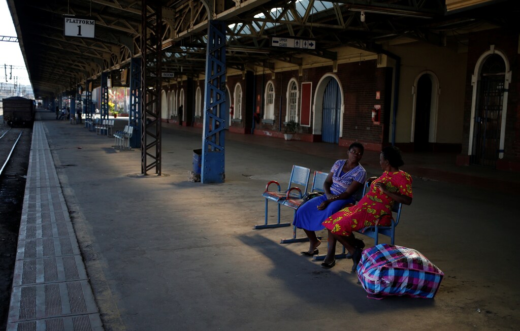 Passengers chat as they wait for a train at a station in Harare, Zimbabwe, August 5, 2018. REUTERS/Siphiwe Sibeko SEARCH "SIBEKO TRAIN" FOR THIS STORY. SEARCH "WIDER IMAGE" FOR ALL STORIES. TPX IMAGES OF THE DAY. - RC194B98E610