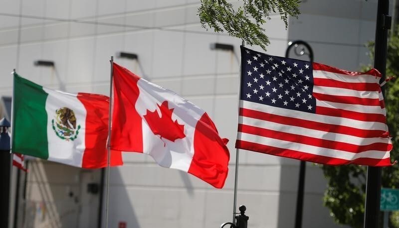 Flags of the U.S., Canada and Mexico fly next to each other in Detroit, Michigan, U.S. August 29, 2018. REUTERS/Rebecca Cook - RC186C7DF0D0
