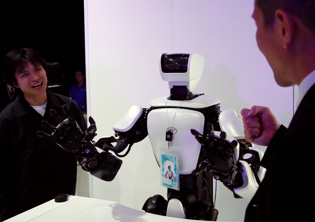 People play rock-paper-scissors with a Toyota T-HR3 humanoid robot at the Tokyo Motor Show, in Tokyo, Japan October 23, 2019. REUTERS/Edgar Su - RC1C46C2F6B0