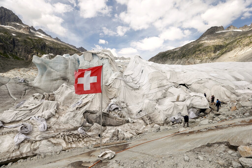 White canvas covers protect parts of the Rhone glacier against melting as visitors enter an ice cave near the Furka mountain pass at 2429 metres (7969 ft) altitude in the Swiss Alps, Switzerland August 6, 2015.