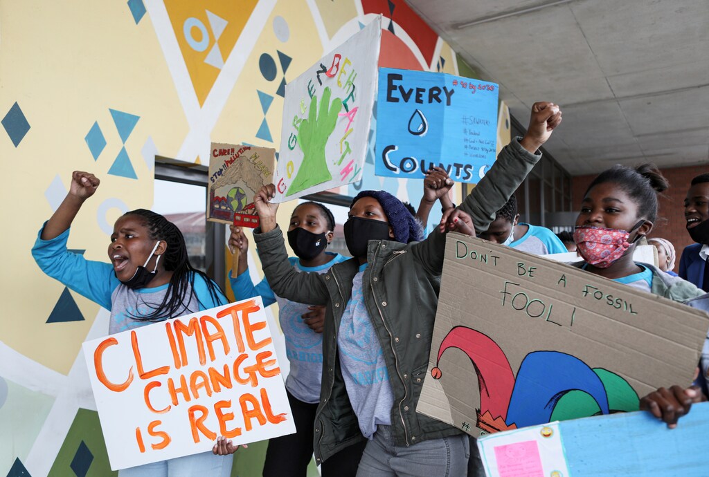 Young activists gesture as they take part in a demonstration during a global day of action on climate change in Khayelitsha township near Cape Town, South Africa