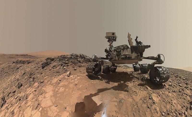 NASA's Curiosity Mars rover is seen at the site from which it reached down to drill into a rock target called 'Buckskin' on lower Mount Sharp in this low-angle self-portrait taken August 5, 2015 and released August 19, 2015. The selfie combines several component images taken by Curiosity's Mars Hand Lens Imager (MAHLI) during the 1,065th Martian day, or sol, of the rover's work on Mars, according to a NASA news release.